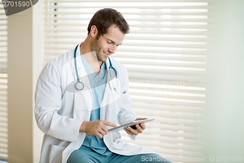 Image of Cancer Specialist Using Digital Tablet At Clinic