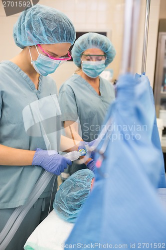 Image of Nurse Adjusting Oxygen Mask On Patient