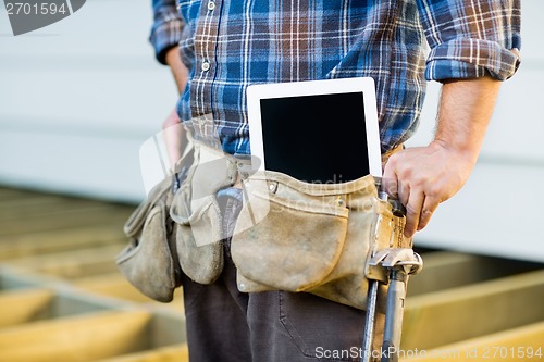 Image of Construction Worker With Tablet Computer In Toolbelt