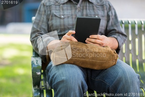 Image of Midsection Of University Student Using Digital Tablet