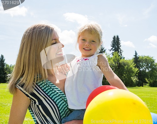 Image of Mother And Daughter With Balloons In Park