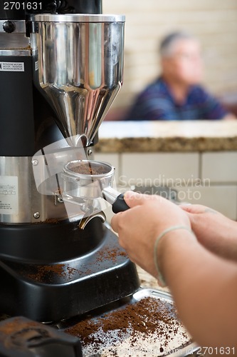 Image of Barista Grinding Coffee