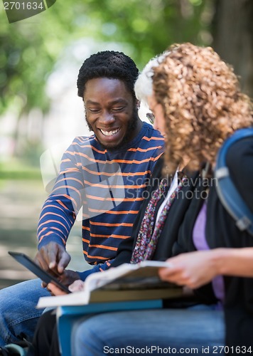 Image of Happy Student Using Digital Tablet With Friends On Campus