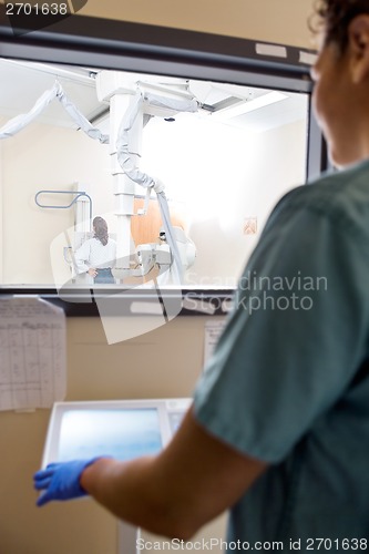 Image of Nurse Operating Machine In Control Room