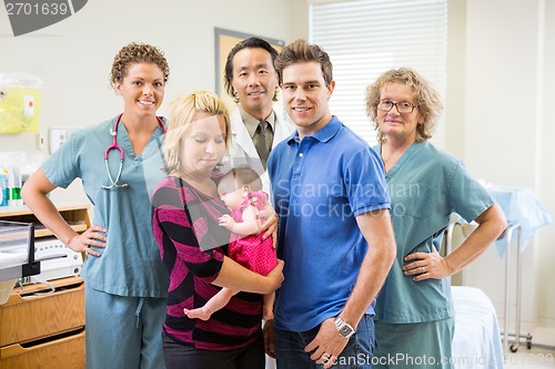 Image of Medical Team With Newborn Baby Girl And Parents In Hospital