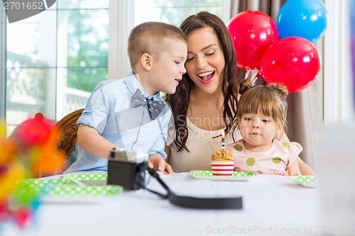 Image of Mother And Children Celebrating Birthday