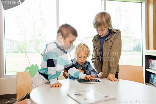 Image of Boys Using Digital Tablet In Library