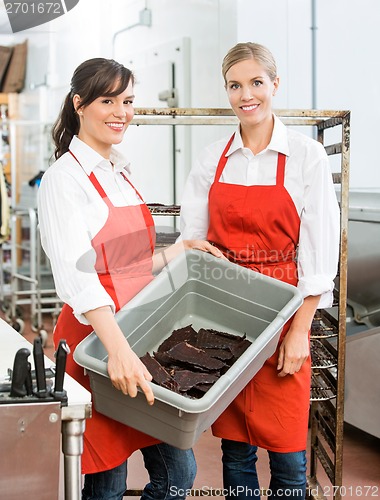 Image of Beautiful Workers Carrying Beef Jerky In Basket At Shop