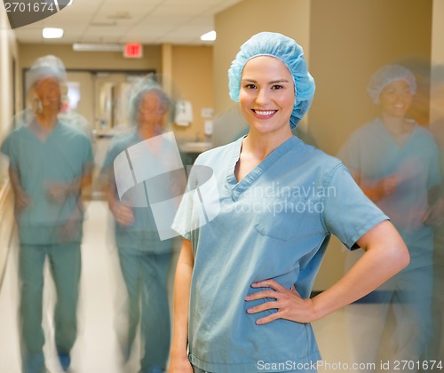 Image of Doctor With Team Walking At Hospital Corridor