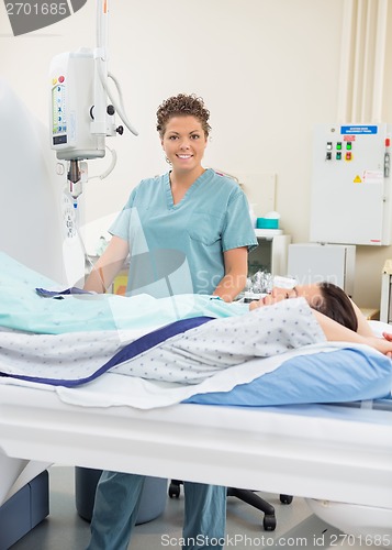 Image of Female Nurse With Patient In CT Scan Room