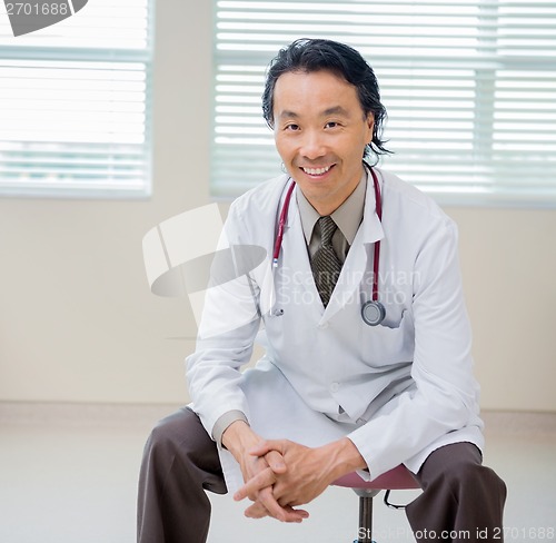 Image of Portrait Of Happy Doctor Sitting In Hospital Room