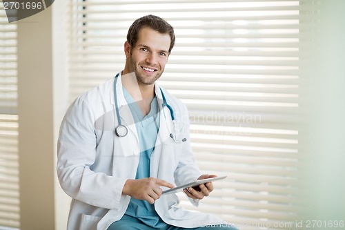 Image of Happy Cancer Specialist Holding Digital Tablet At Clinic