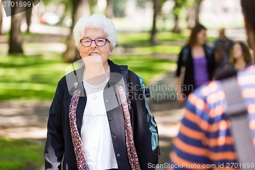 Image of Senior Female Professor Standing On Campus