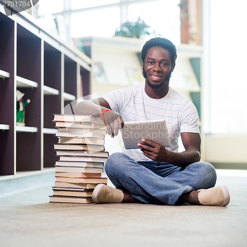 Image of Student With Books And Digital Tablet Sitting In Library