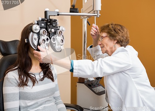 Image of Optometrist Examining Young Woman's Eyes