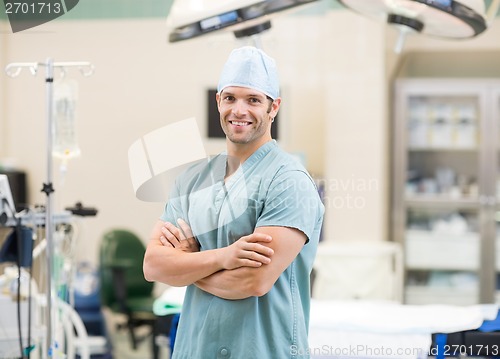 Image of Surgeon Standing Arms Crossed In Operation Room