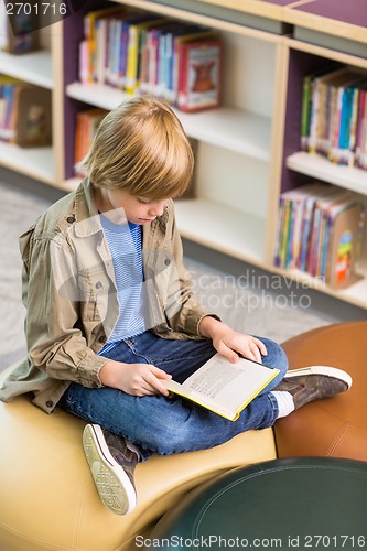 Image of Boy Reading Book In School Library