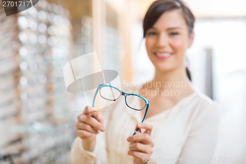 Image of Woman Showing Glasses At Store