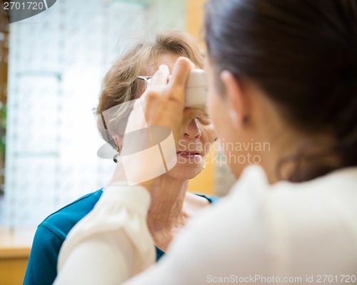 Image of Optometrist Examining Senior Woman's Vision