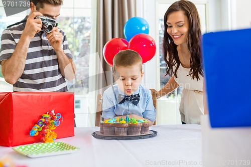 Image of Family Celebrating Son's Birthday At Home