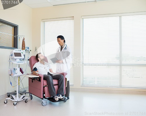 Image of Doctor With Digital Tablet Discussing With Patient In Chemo Room