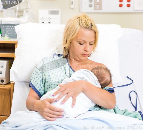 Image of Woman Breast Feeding Newborn Babygirl In Hospital