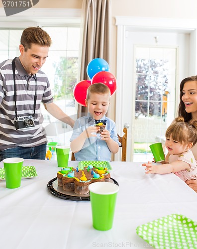 Image of Family Celebrating Boy's Birthday At Home