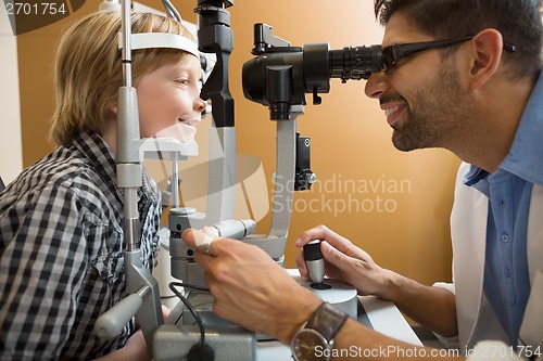 Image of Optometrist Examining Boy's Eyes With Slit Lamp