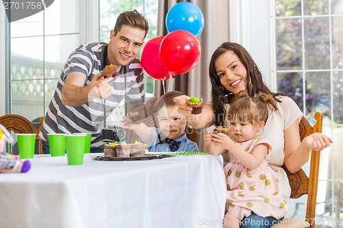 Image of Family Showing Cupcakes At Birthday Party