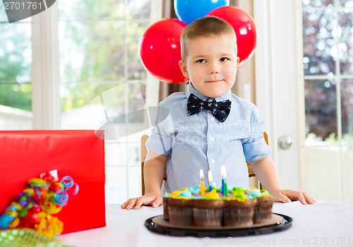 Image of Birthday Boy With Cake And Present On Table