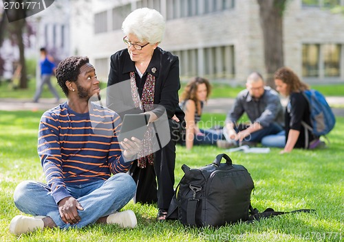 Image of Professor Helping Student on Digital Tablet