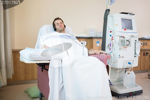 Image of Patient Sleeping While Listening Music at Dialysis Center