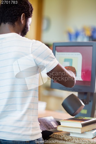 Image of Librarian Scanning Books At Library Counter