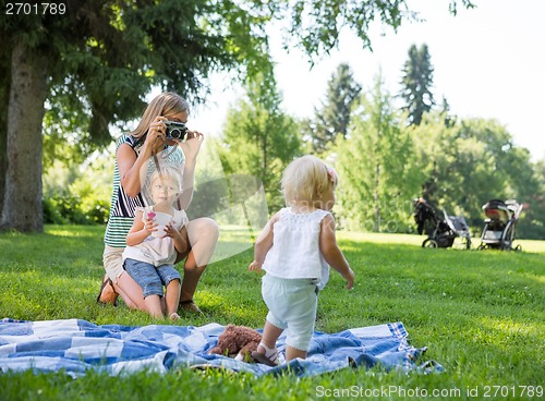 Image of Mother Photographing Daughter In Park