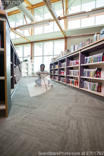 Image of Student With Stack Of Books In Library