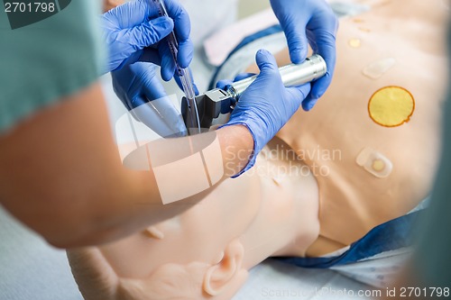 Image of Medical Team Adjusting Tube In Dummy Patient's Mouth