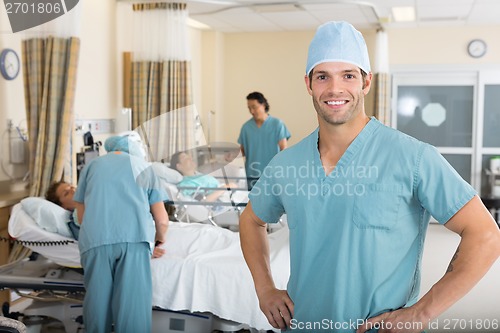 Image of Male Nurse With Colleagues Examining Patient's