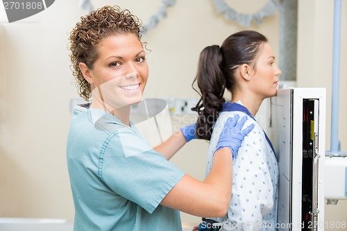 Image of Nurse Preparing Young Patient For Chest Xray