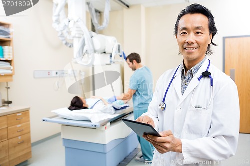 Image of Doctor Using Digital Tablet In Hospital Room