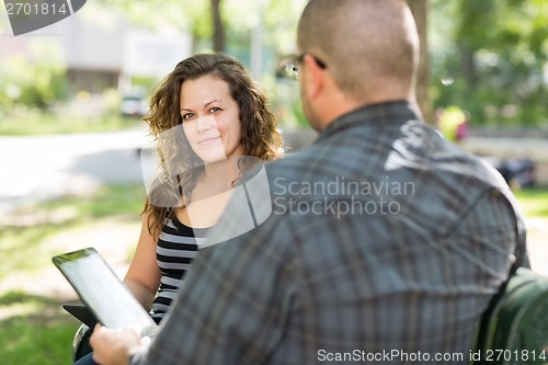 Image of Female Student Sitting With Male Friend At Campus