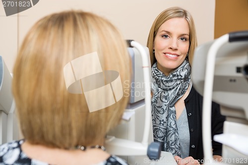 Image of Optometrist Using Tonometer to Measure Patients Eye Pressure