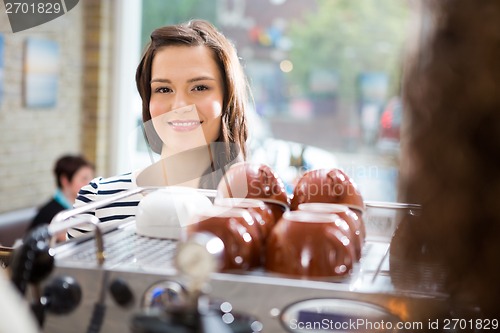 Image of Woman Standing At Counter In Coffeeshop