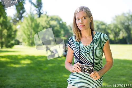 Image of Woman With Digital Camera In Park