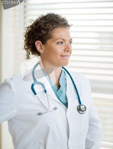 Image of Thoughtful Doctor Looking Away In Clinic