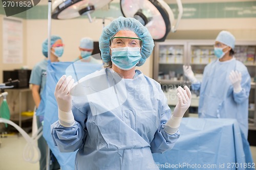 Image of Doctor In Surgical Gown With Team At Operation Room