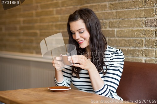 Image of Beautiful Woman Smiling While Drinking Coffee
