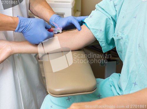 Image of Doctor Drawing Blood From Female Patient's Arm