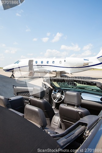 Image of Jet Plane And Convertible At Terminal