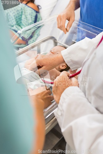 Image of Doctor Examining Newborn Babygirl In Hospital