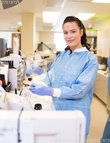 Image of Medical lab tech performing urine analysis in lab